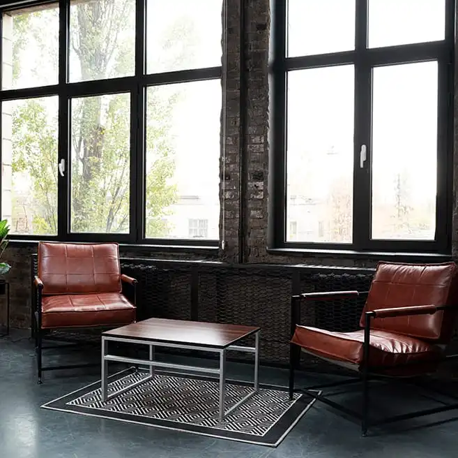 Miguel A. del Barrio: interior tipo loft con grandes ventanales de marco negro y zona de estar